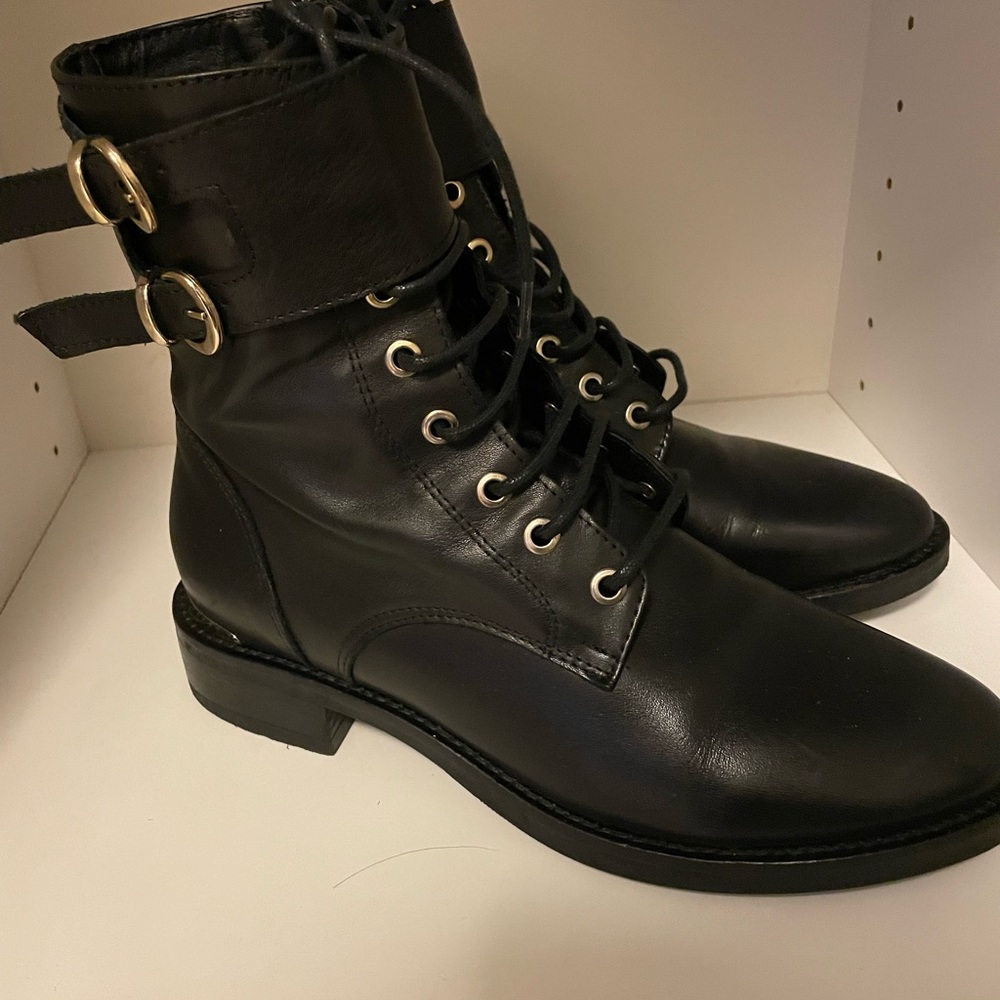 Laced up black boots with gold detail on the back. It’s slightly used.